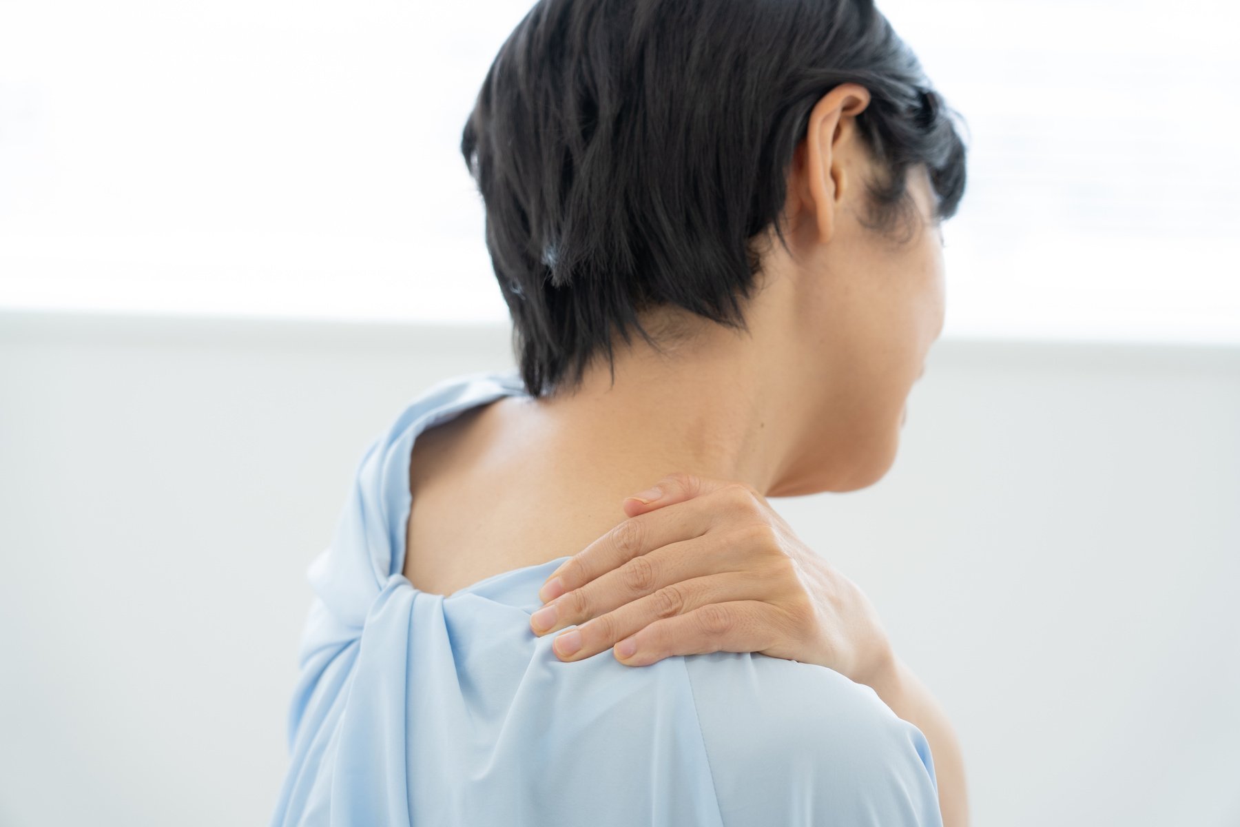 Woman suffering from stiff shoulders